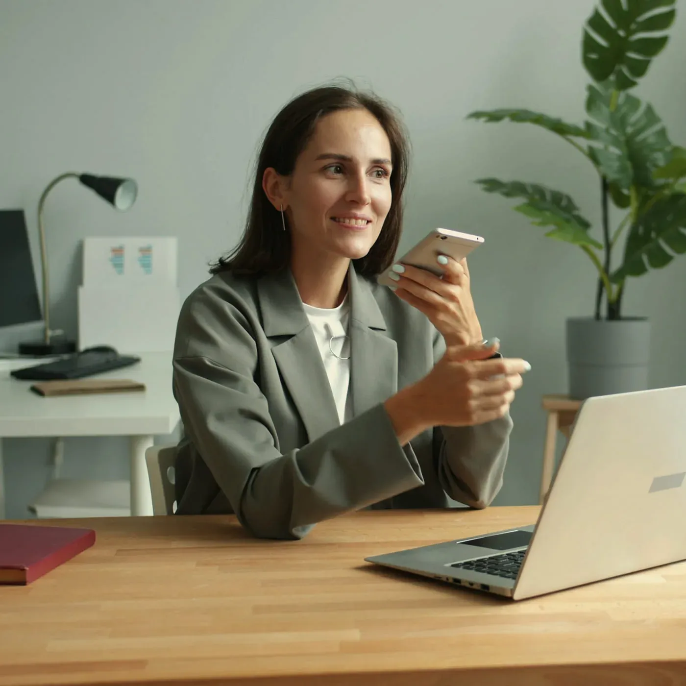 A Magnifito consultant taking a client call at a desk with a laptop